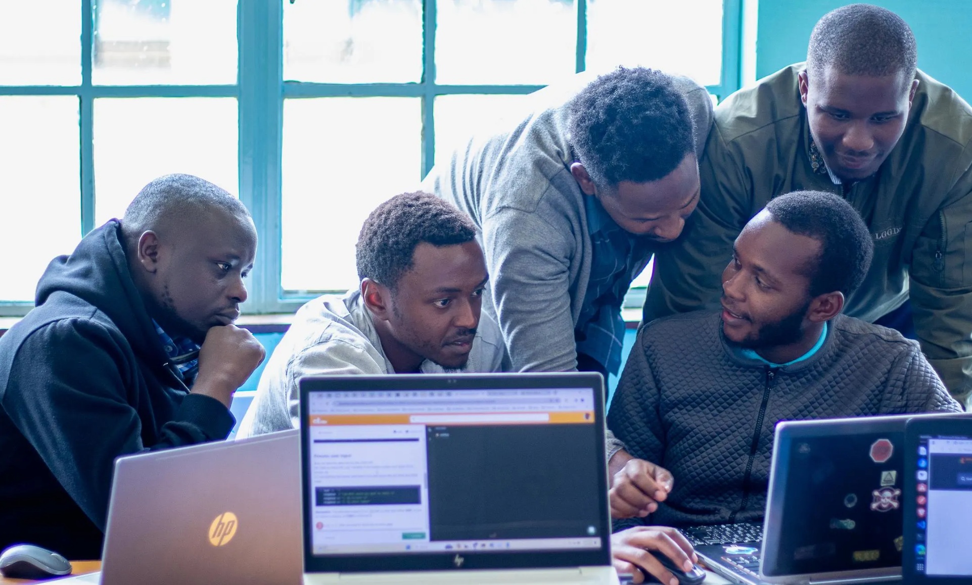 Africa professional tech team collaborating in modern office environment